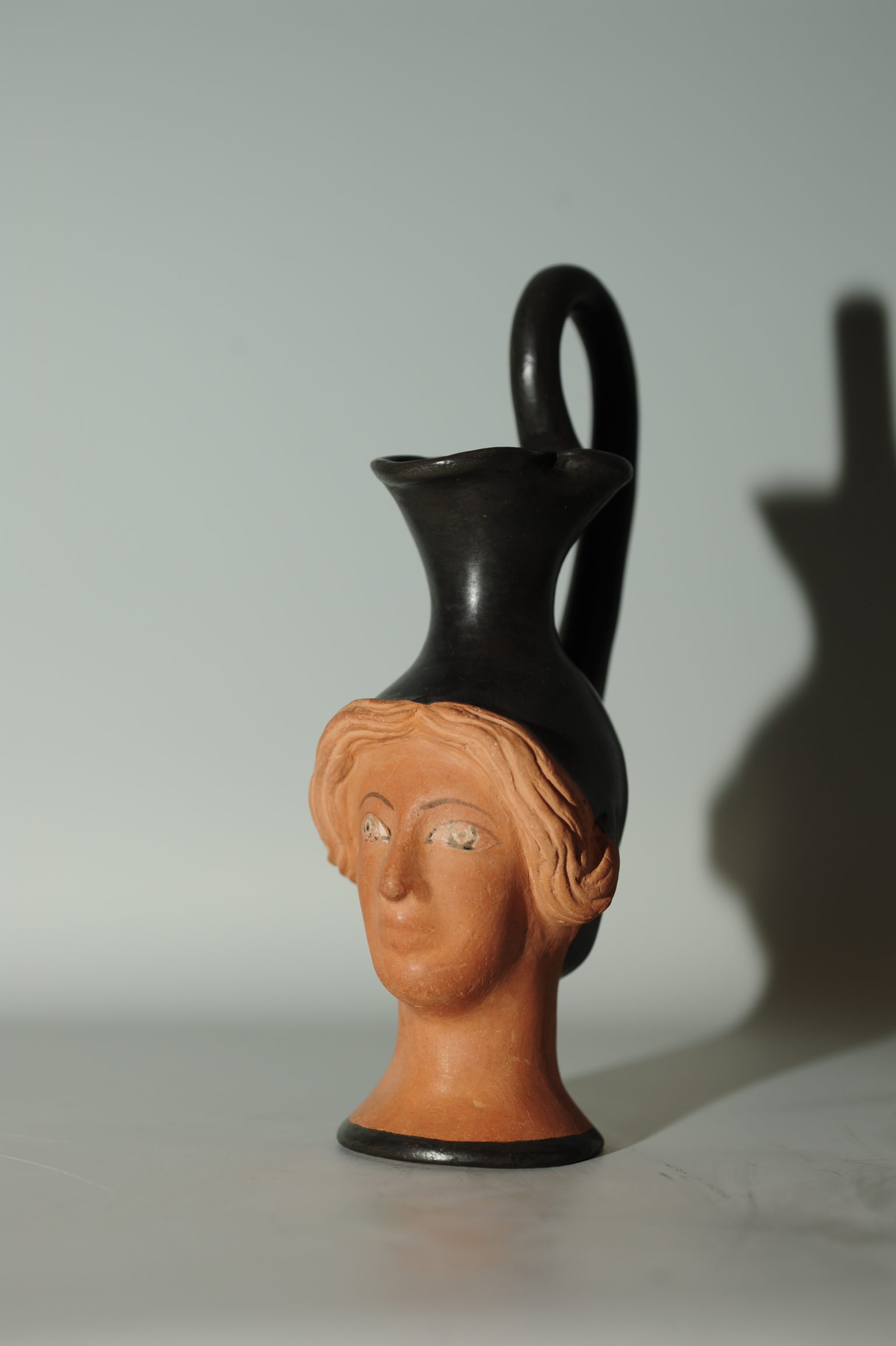 An Attic head-vase Oinochoe