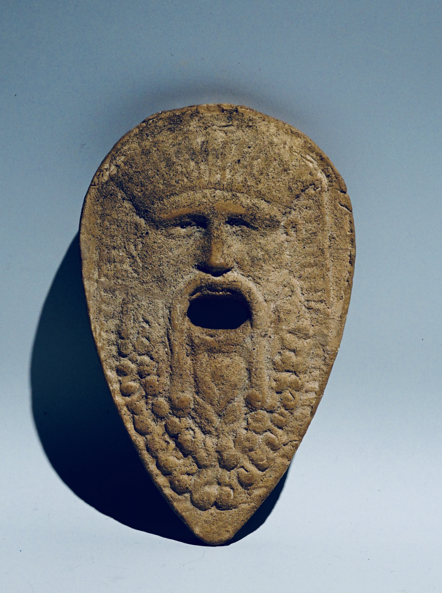 A Votive Mask in the form of a Bearded Man